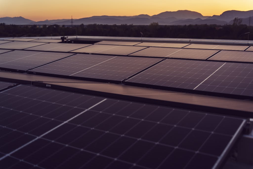 Solar panels in Styria, Austria under a serene sunset, showcasing renewable energy.